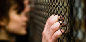 woman behind fence