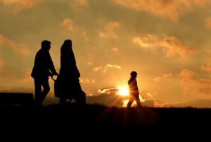 refugees walking in sunset