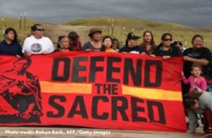 Dakota Access Pipeline protesters stand with banner