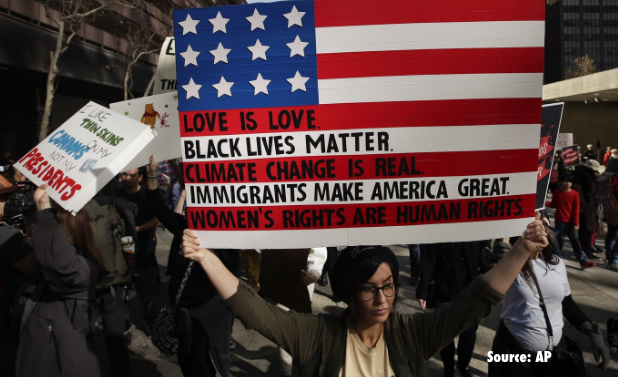woman holding an american flag during a protest