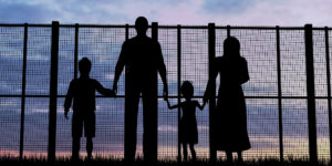 Silhouette of a refugee family with children