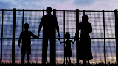 Silhouette of a refugee family with children