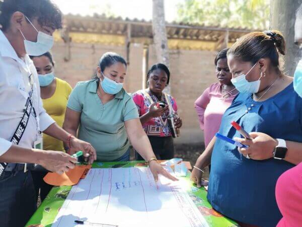A group of organization members looking through a chart