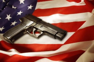 A handgun lying on top of an American flag