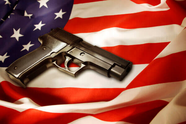 A handgun lying on top of an American flag