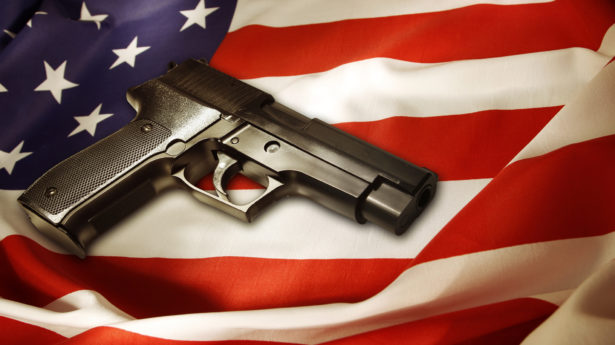 A handgun lying on top of an American flag