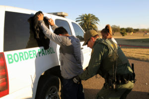 US Border Patrol agent detains a migrant at the southern border