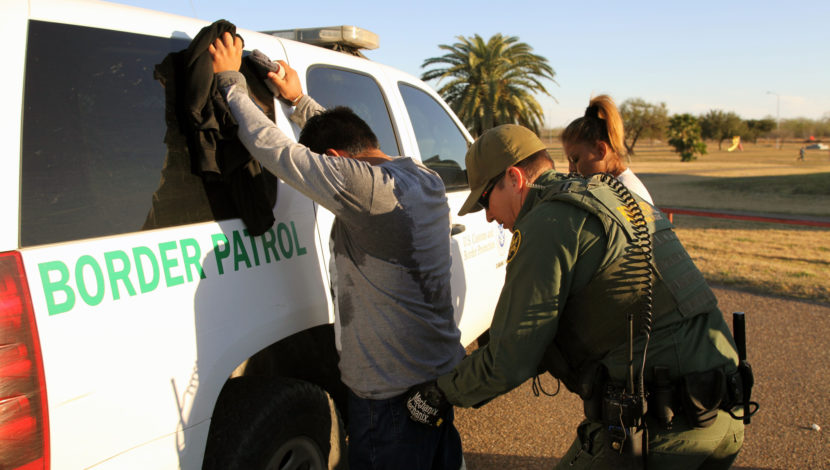 US Border Patrol agent detains a migrant at the southern border