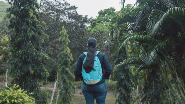 A young woman walking in a forest