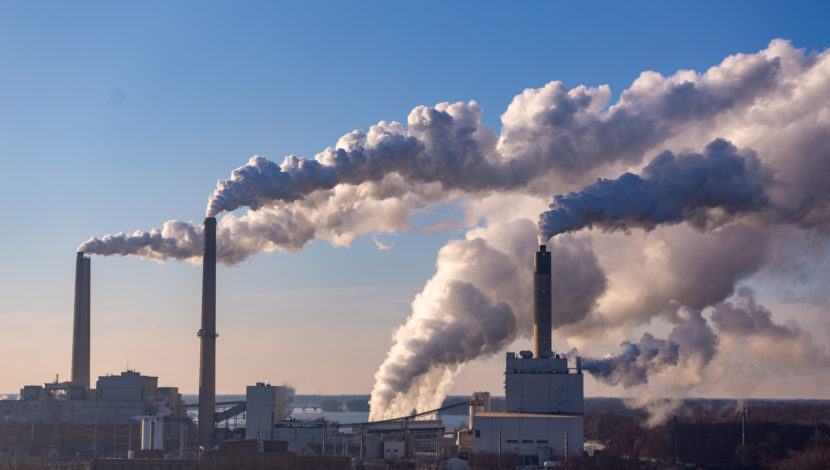 Wind blowing pollution from a coal burning power plant.