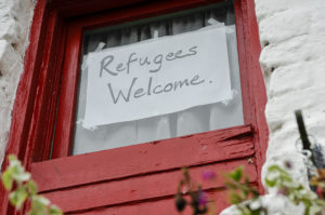 A sign reading "Refugees Welcome"