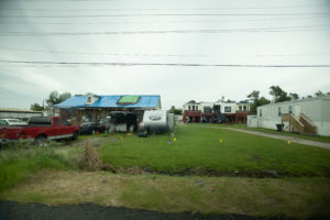 Three homes close together; a trailer sits in front of one of the homes