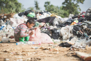 a poor boy collecting garbage