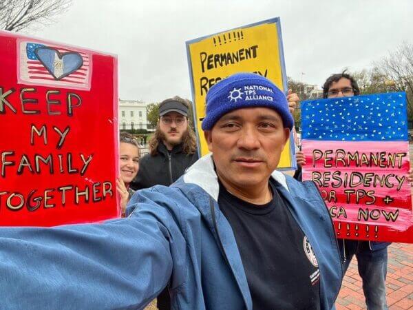 Selfie photo of National TPS member standing along side other supporters with messages of solidarity