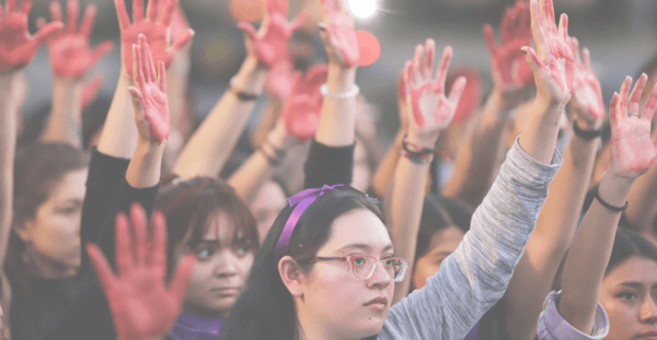 A group of women with their hands in the air