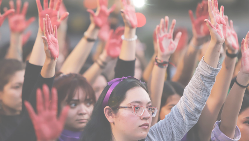 A group of women with their hands in the air