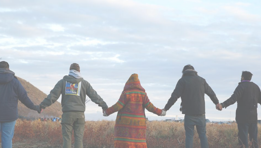 A group of Indigenous people holding hands