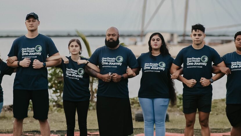 A group of climate activists forming a chain through linking arms