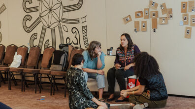 UUSC staff member speaks with fellow funders.