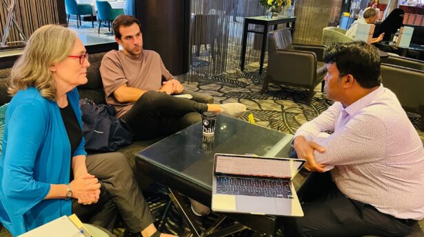 Two UUSC staff members speak with a UUSC partner.