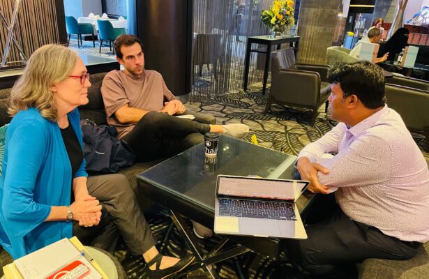 Two UUSC staff members speak with a UUSC partner.