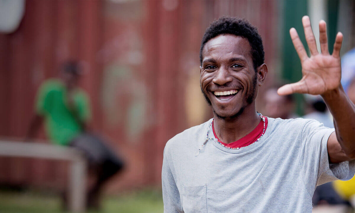 Young man waving in Papua, New Guinea
