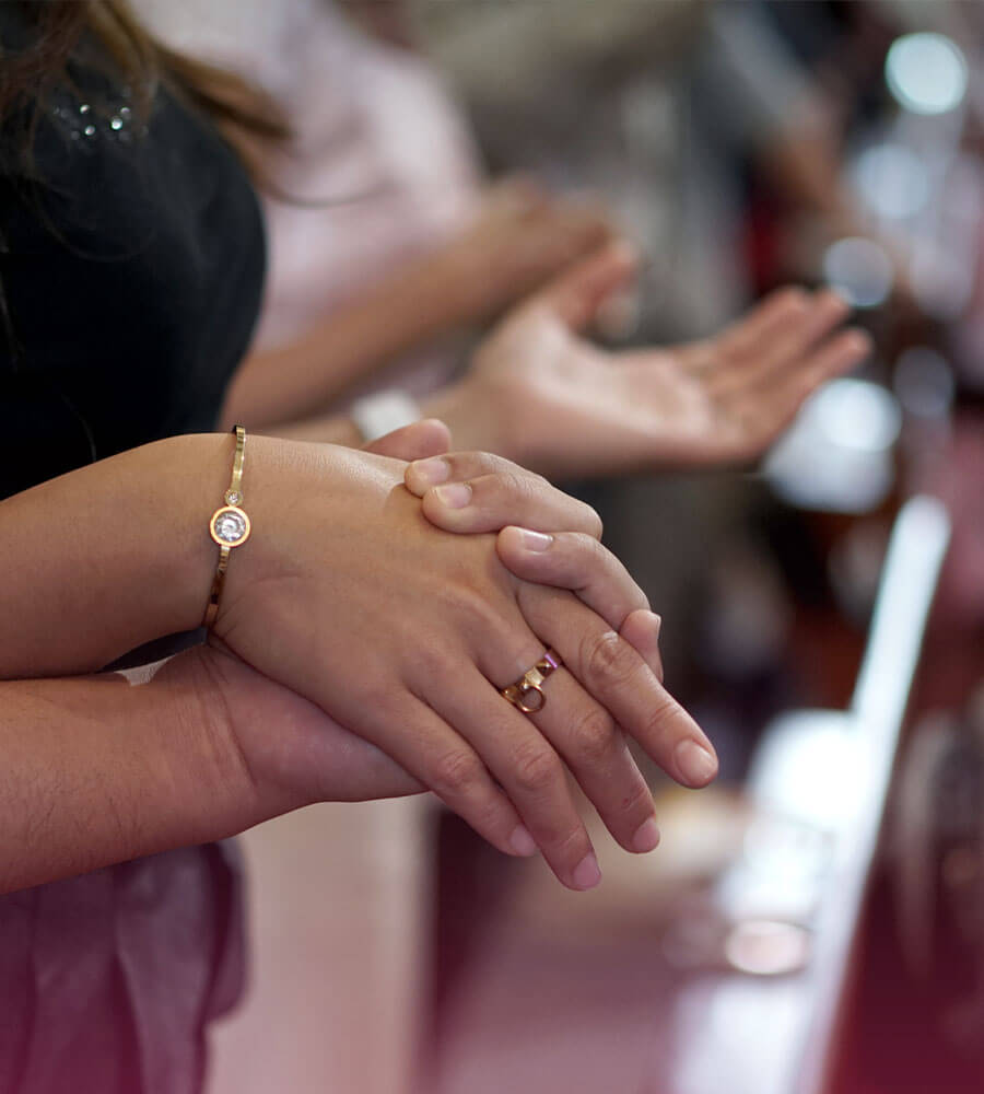 People holding hands at a congregation gathering