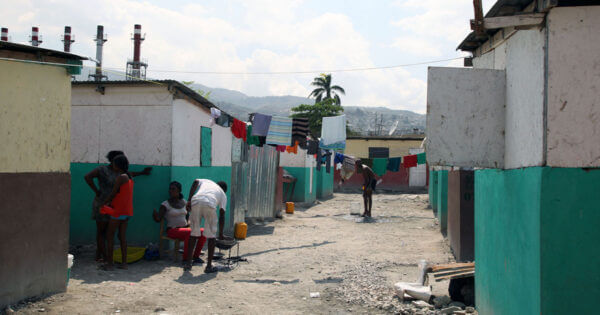 Neighbors gather on a corner of the street in Camp Chavez in the Carrefour neighborhood of Port-au-Prince, Haiti