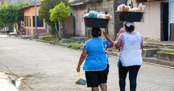 Women carrying basins with food on their heads in Leon, Nicaragua