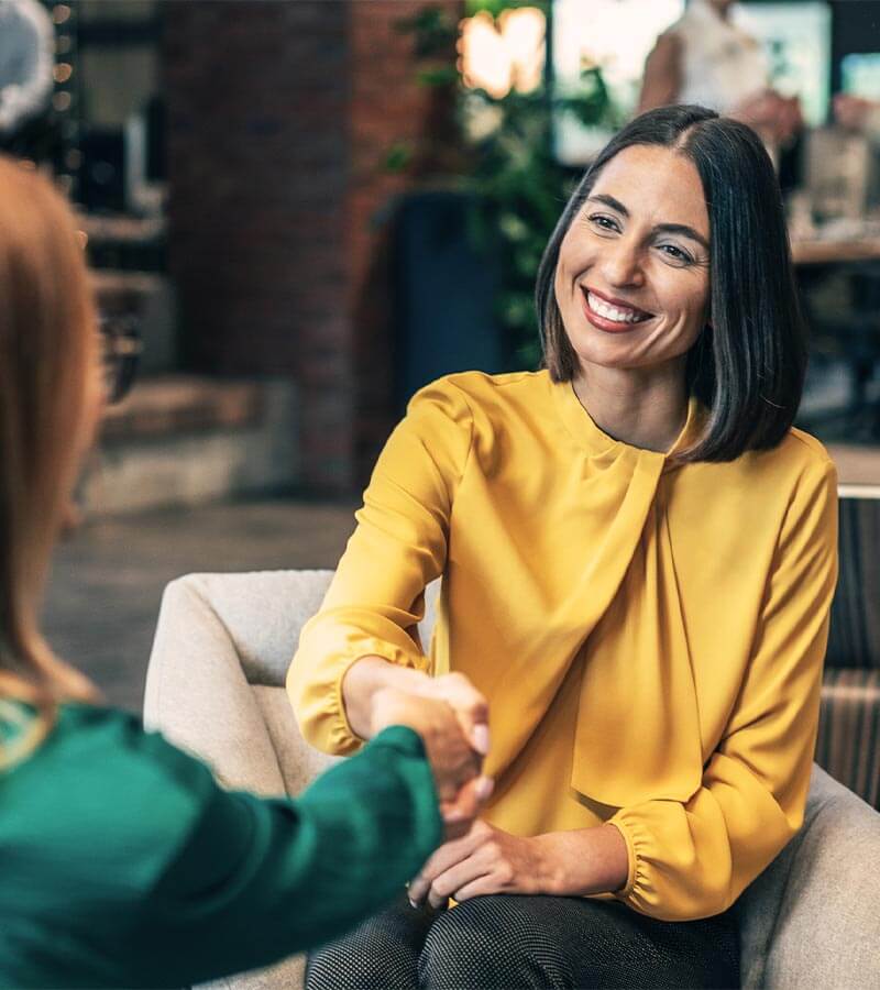 Woman being greeted at a job interview