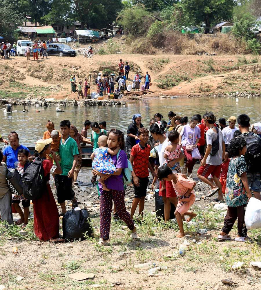 Refugees from Myanmar crossing the border into Thailand