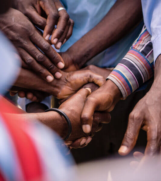 A group of leaders in Haiti hold hands