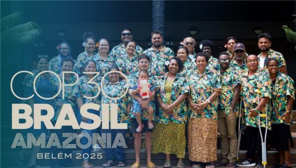 A diverse group of Pacific Rising attendees wearing matching tropical shirts posing happily together. Text on the left reads "COP30 Brasil Amazônia Belém 2025".