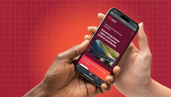 hands holding phone that showcase new UUSC website